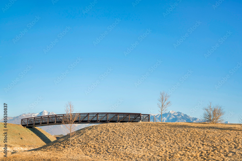 Fototapeta premium Wooden footbridge over Oquirrh Lake at Daybreak in Utah