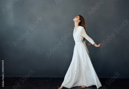 woman white dress fashion elegant style studio dark background posing