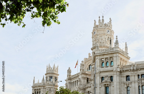 Towers of city hall in Madrid, Spain. Historical building known as Palacio de Cibeles, view from the park