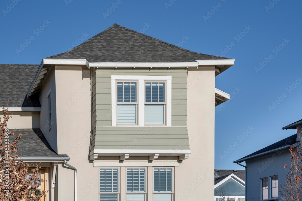 Exterior of a house with asphalt shingle roof and decorative wall