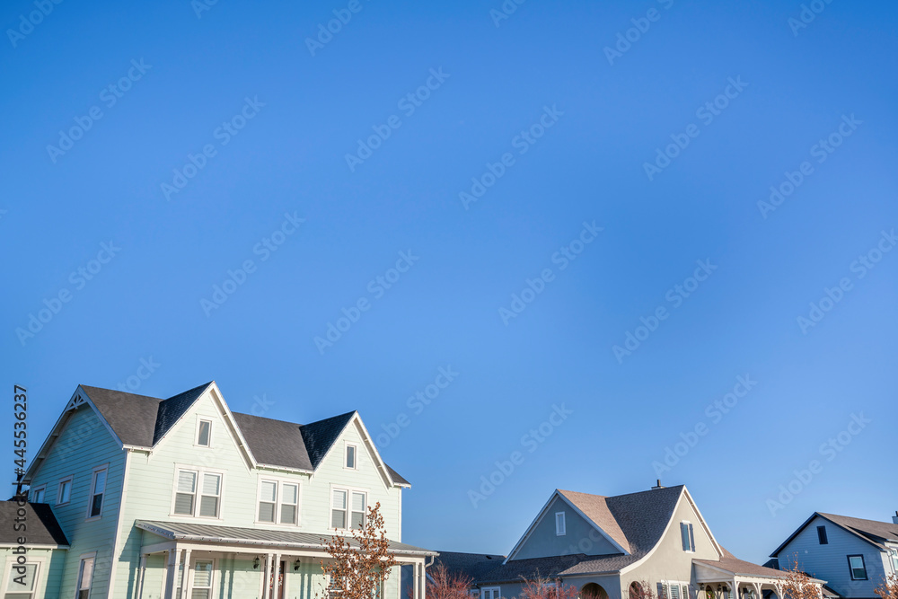 View of an upper part of a two-storey houses with different structures and colors View of an upper part of a two-storey houses with different structures and colors