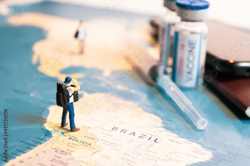 Konstfotografi Miniature traveler looking for vaccine passport