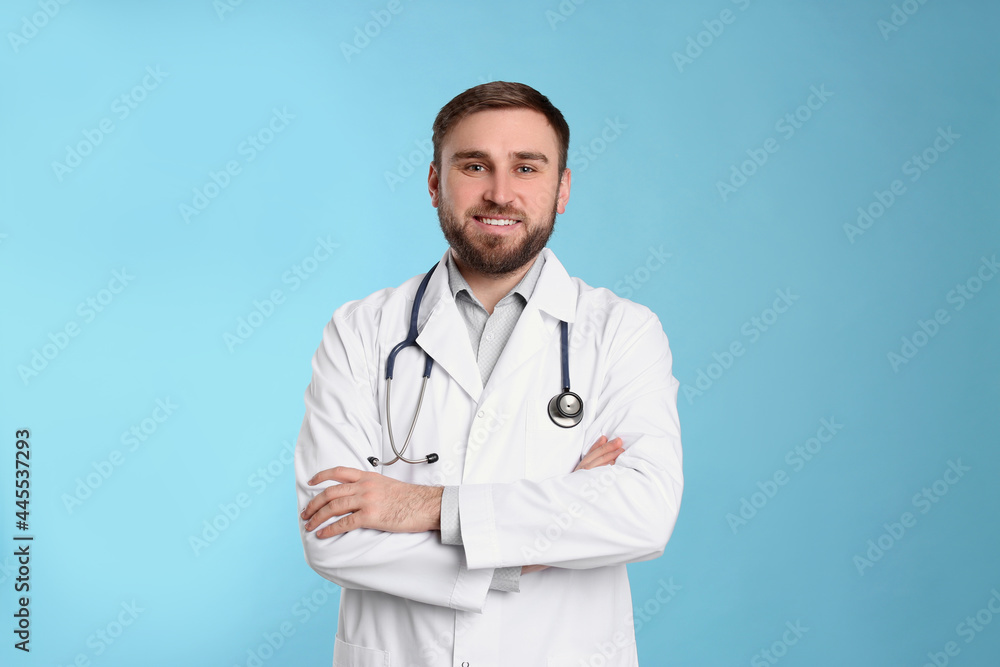 Pediatrician in uniform with stethoscope on light blue background Pediatrician in uniform with stethoscope on light blue background