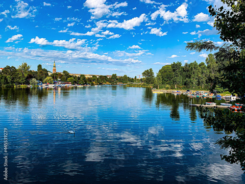 Beautiful day with a bright sky filled with white clouds over a lovely lake in the Setagaya Park photo