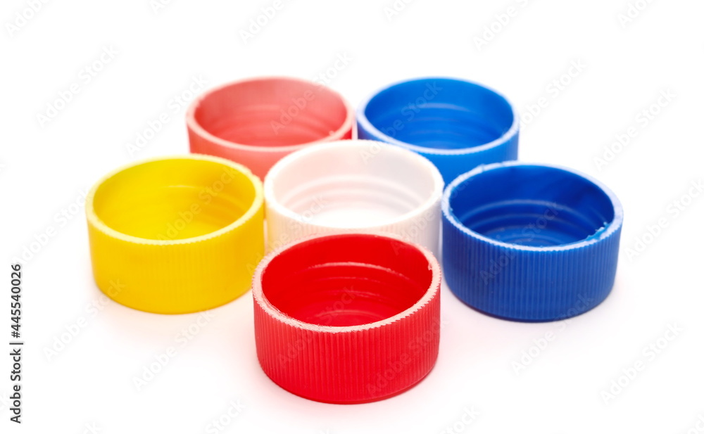 Colorful plastic bottle caps pile isolated on white background Colorful plastic bottle caps pile isolated on white background