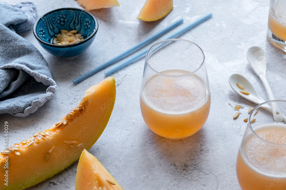 Fresh melon juice on the table, preparing melon juice by raw ripe biological fruit, food background Fresh melon juice on the table, preparing melon juice by raw ripe biological fruit, food background