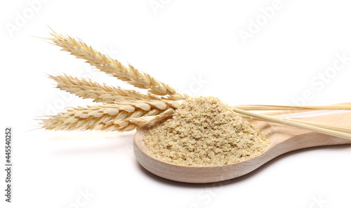 Wheat germ pile in wooden spoon and wheat ears isolated on white background