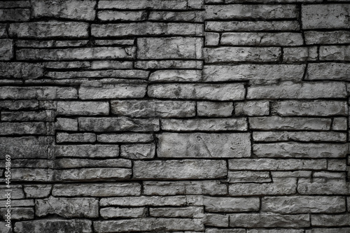 Black old brick wall. Collapsing brickwork. Grunge background with copy space for design. Distressed background.