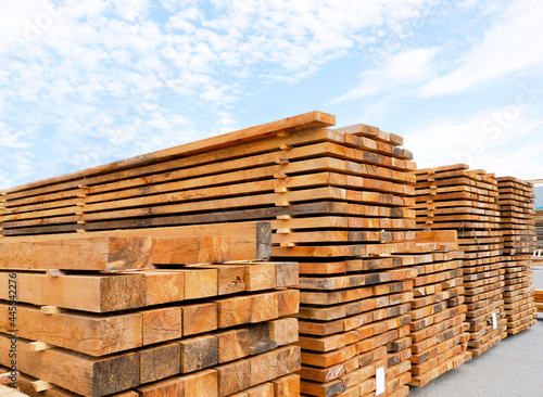 Stack of lumber and planks in a lumber warehouse outdoors