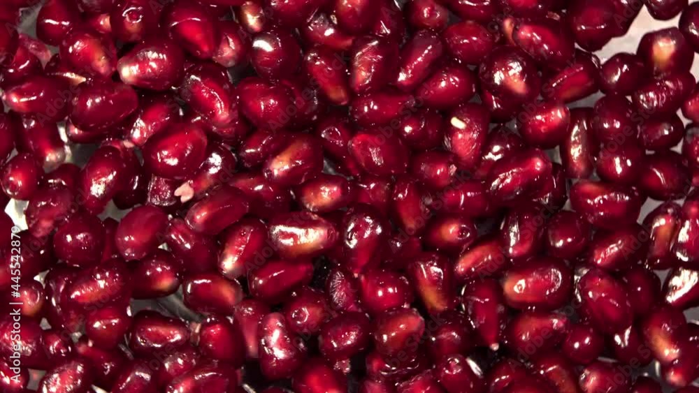 Pomegranate seeds on a rotating surface macro shot Pomegranate seeds on a rotating surface macro shot