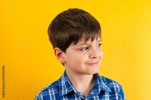 Cute smiling boy on yellow background
