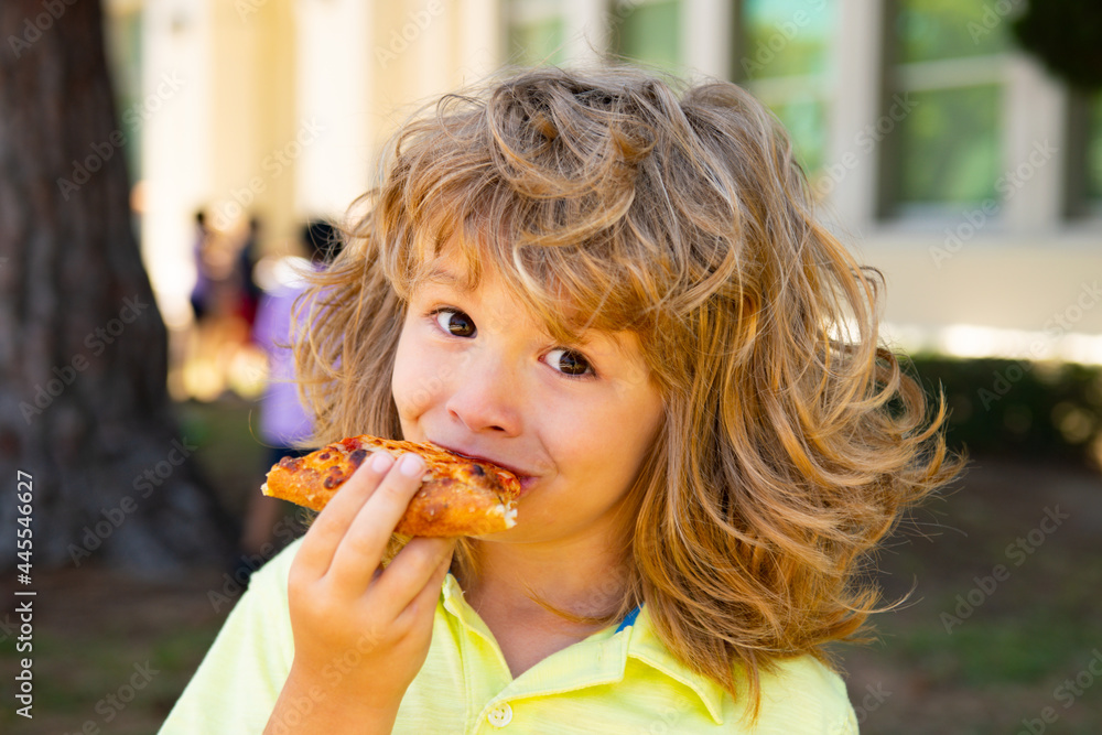 Child boy eating a piece of pizza. Kid eats a slice of pepperoni pizza. Kids love pizza. Child boy eating a piece of pizza. Kid eats a slice of pepperoni pizza. Kids love pizza.