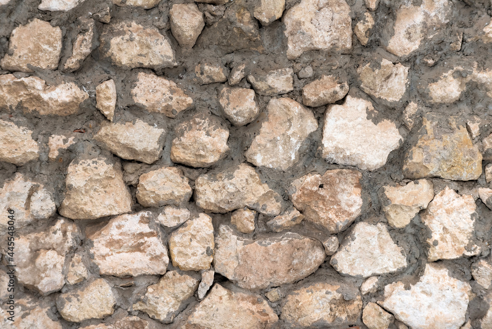Neatly stacked rough cut stone wall seamless texture background Neatly stacked rough cut stone wall seamless texture background