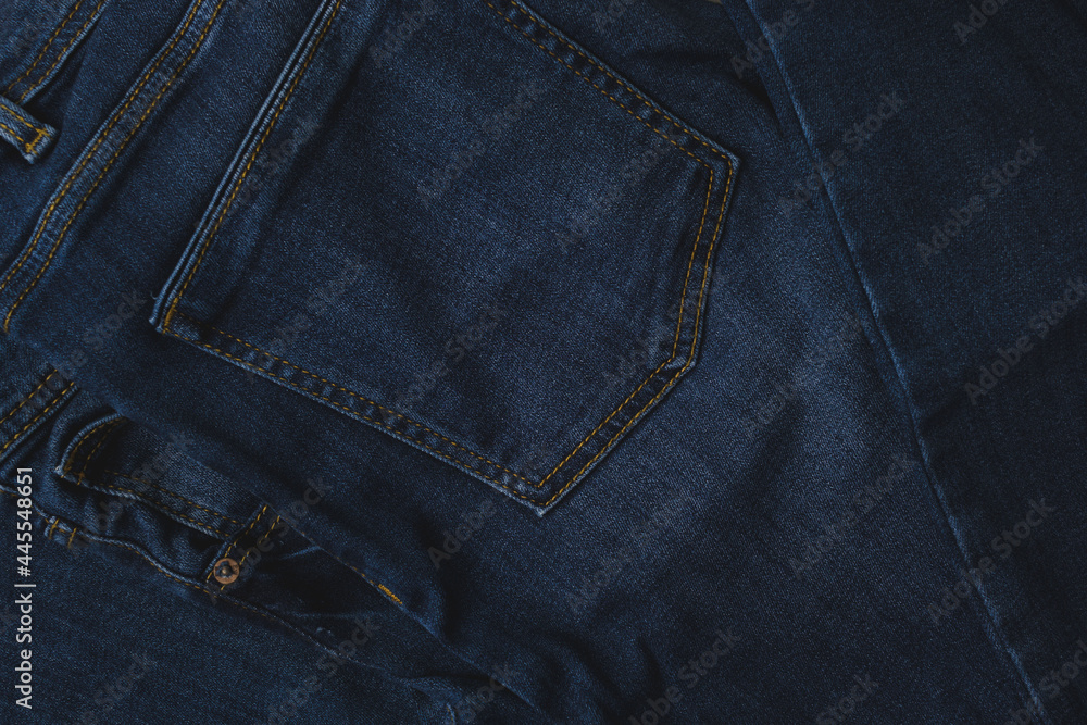 Closeup of dark blue jeans with seam and pockets. Texture background with copy space. Closeup of dark blue jeans with seam and pockets. Texture background with copy space.