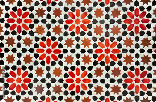 Decorative background in arabic mosaic style. Morocco style star tiles. Composition of star tiles in red, brown and black color on a white background. photo
