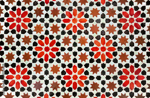 Decorative background in arabic mosaic style. Morocco style star tiles. Composition of star tiles in red, brown and black color on a white background.