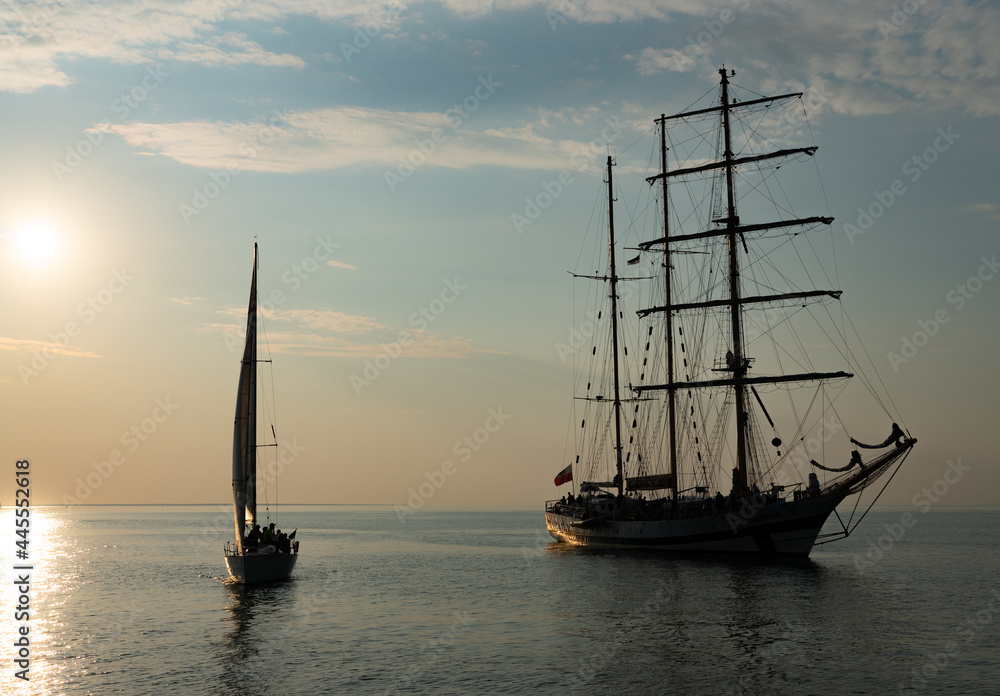 Sailing boat achored on Tallinn bay. 3 mast sailing yacht enjoying the sunset on calm Baltic sea. Beautiful weather and nice sky
