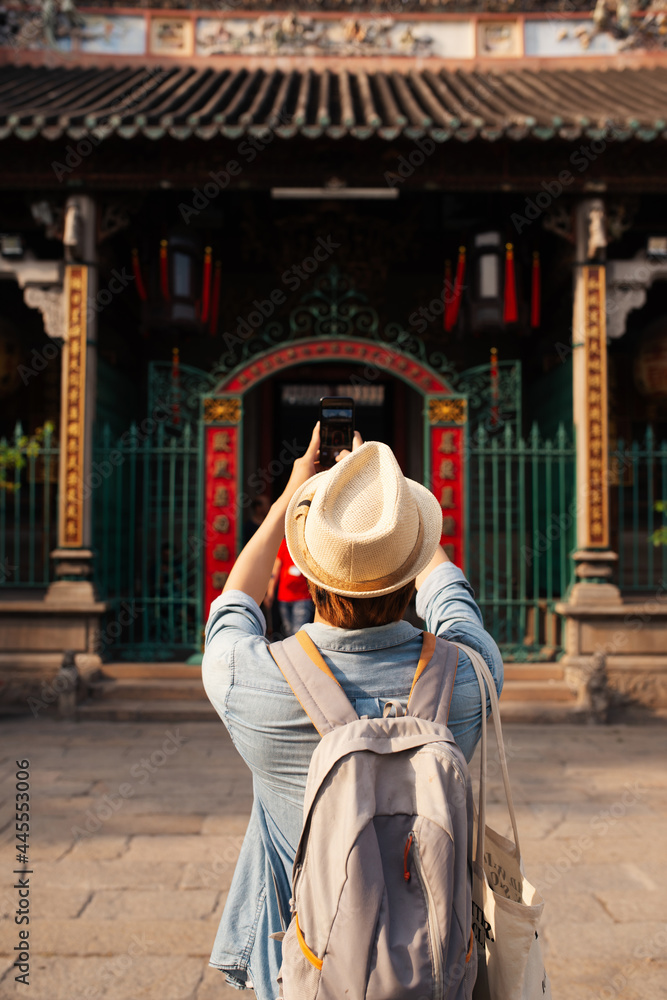 Asian man take a photo at the temple.