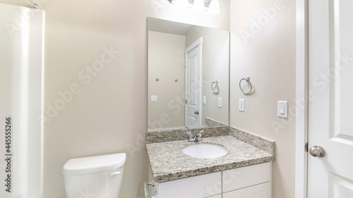 Pano Small white bathroom interior with ambient lightnings and closed white door