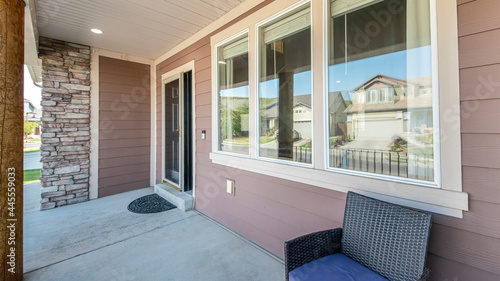 Pano Front exterior of a house with windows, door and stone brick wall