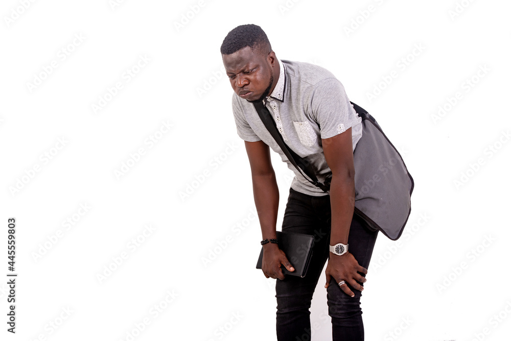 young tired student man holding his hands on his knees. young tired student man holding his hands on his knees.