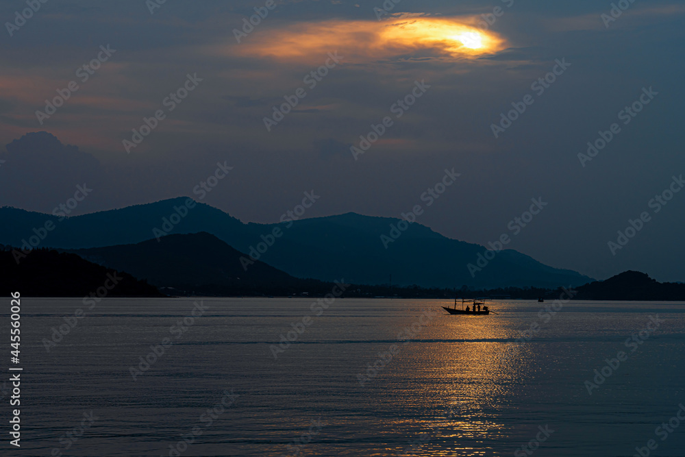 Nature view sunset of shadow fisherman in the sea and mountain on the island background