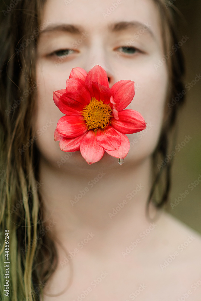 girl holding a red flower in her mouth. Concept photo girl holding a red flower in her mouth. Concept photo