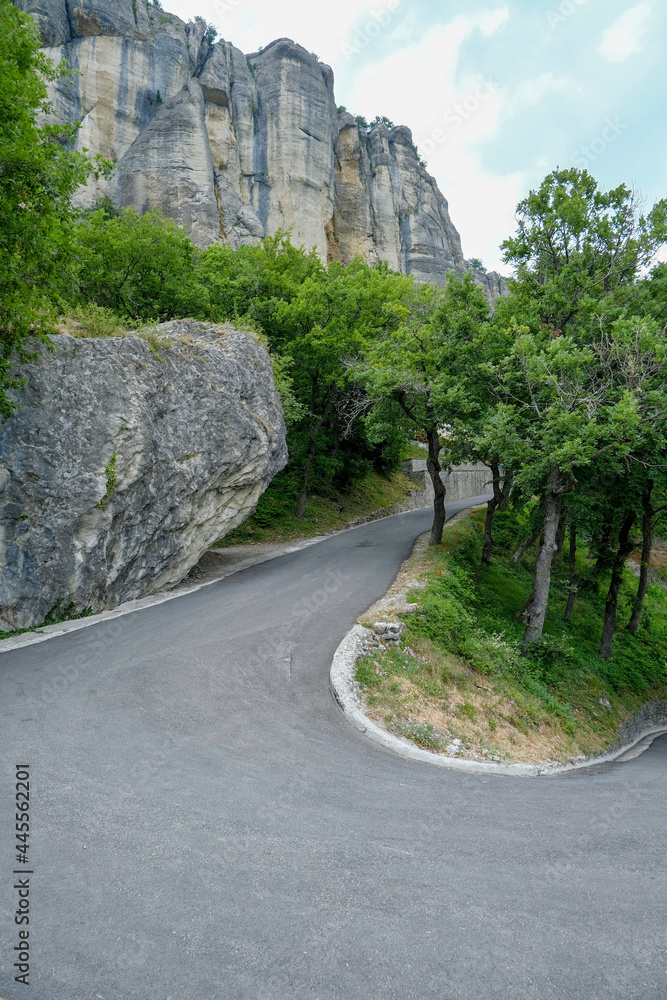 Fototapeta premium mountain road in the mountains. View of the Pietra di Bismantova rock in Italy, Reggio Emilia from beneath