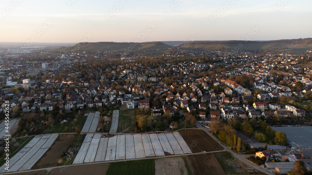 Fototapeta Aerial shot of urban houses and landscapes with sunlit