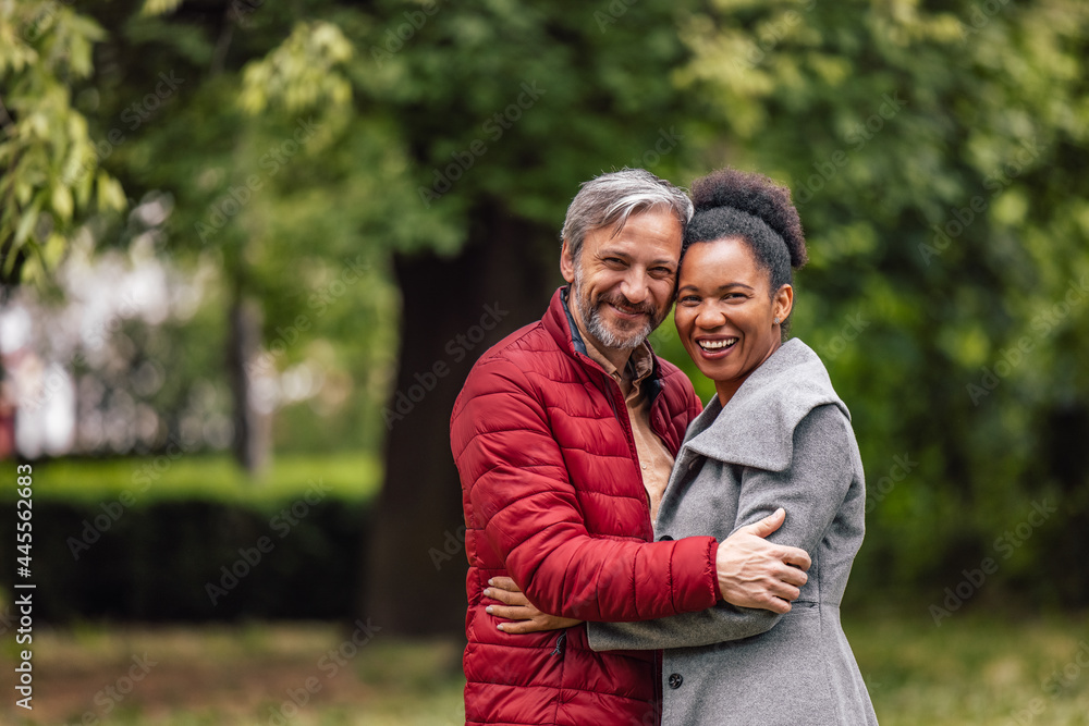 Adult couple, looking in the camera, while smiling. Adult couple, looking in the camera, while smiling.