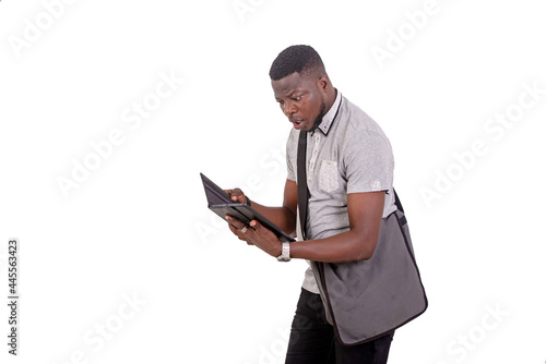 surprised young man receives bad news on a digital tablet.