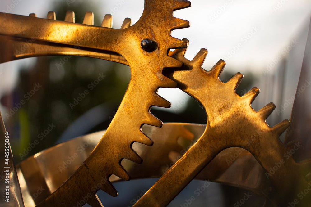 Gears in sunlight. Copper-colored movement. Gears in sunlight. Copper-colored movement.