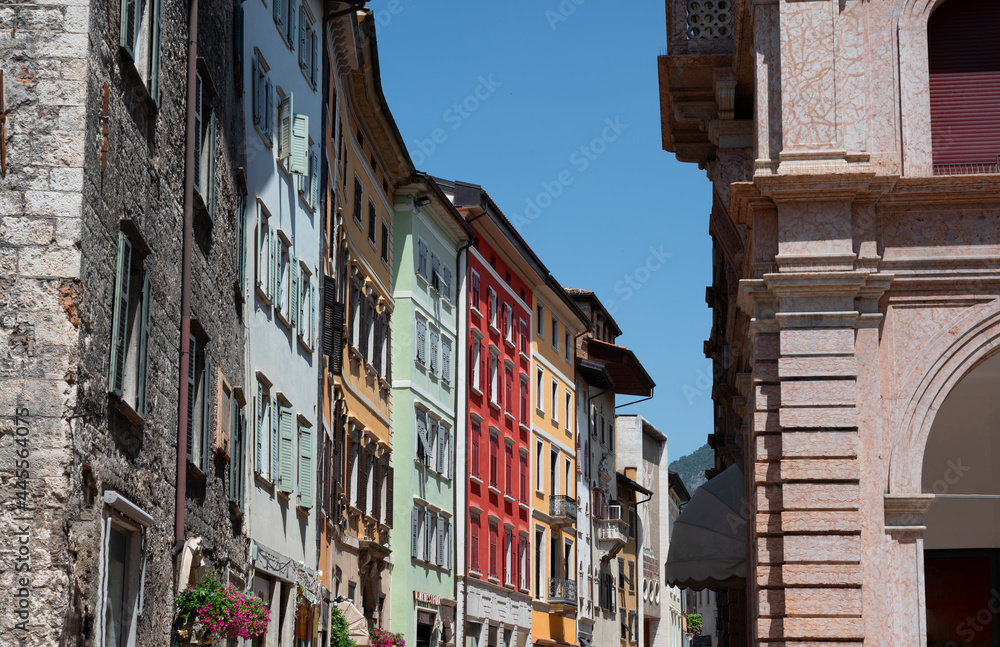 Trento, Italy, June 2021. Beautiful view of one of the streets of the historic center characterized by brightly colored facades. Beautiful summer day.