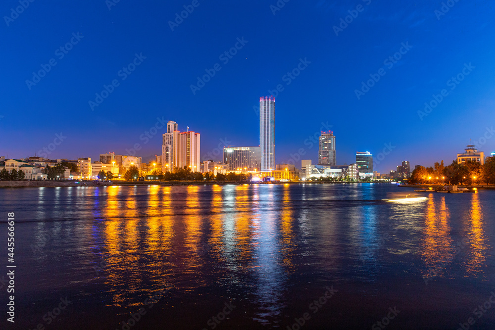 Night view of the skyscrapers of the city of Yekaterinburg. Russia. Reflection in the river