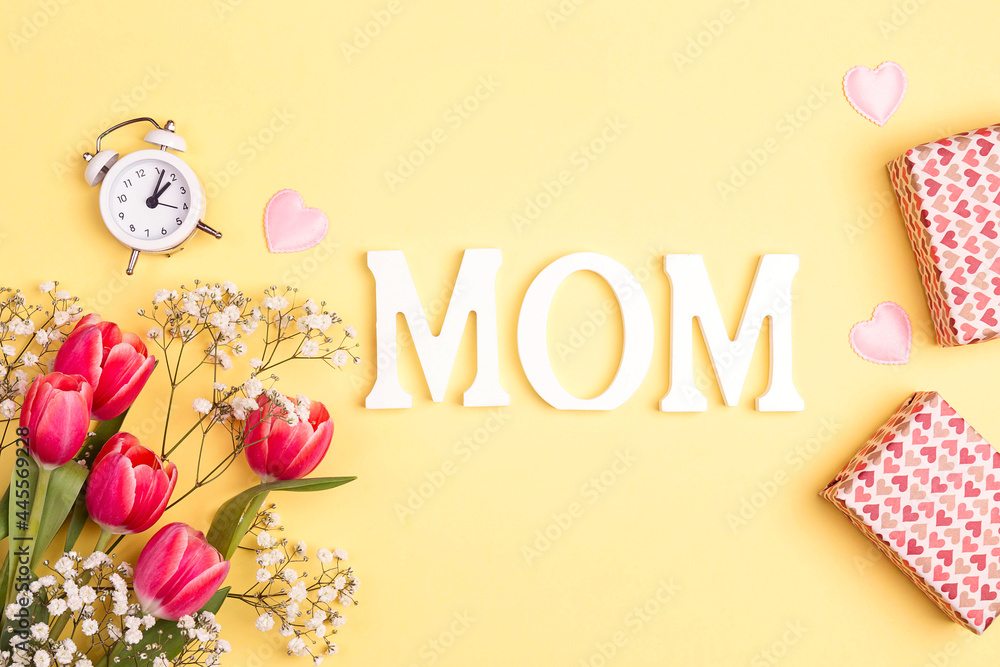 Mothers day background with tulips, gifts and alarm clock. Mothers day background with tulips, gifts and alarm clock.