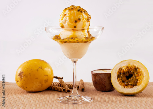 Passion fruit ice cream in a bowl with ingredients in the decoration
