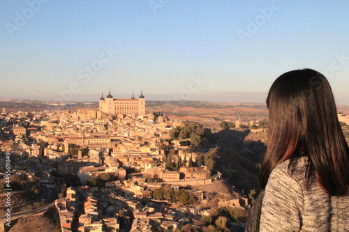 Woman staring at the medieval city of Toledo