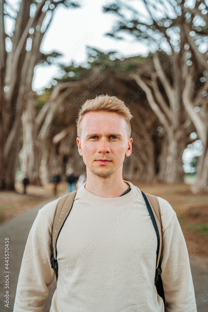 Dramatic landscape and a young man in the Cypress Tree Tunnel near San Francisco, USA Dramatic landscape and a young man in the Cypress Tree Tunnel near San Francisco, USA