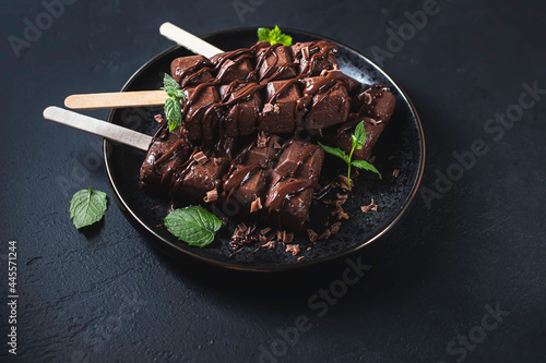 Homemade chocolate ice cream on dark background.