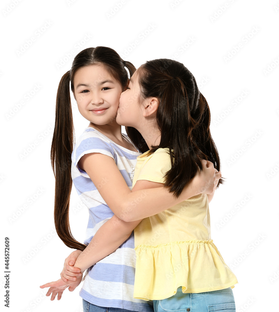 Cute Asian sisters on white background