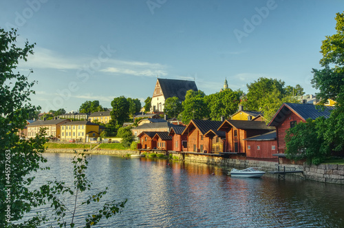 1800 19th century style red fishermen's harbor warehouses in Porvoo Finland with Church background