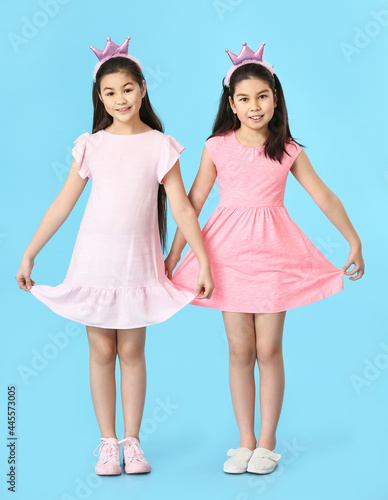 Cute Asian sisters on color...