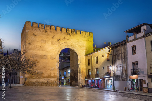 Granada, Spain. View of historic Gate of Elvira (Puerta de Elvira) at dusk photo