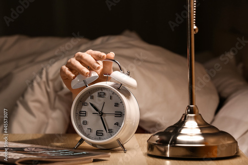 Woman turning off alarm clo...