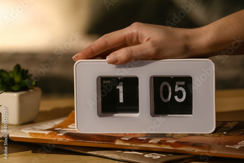 Woman with alarm clock and ...