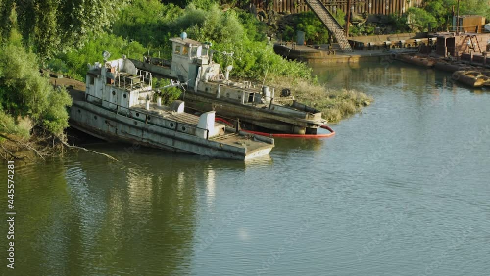Two abandoned ships on the backwater bow are on land in the trees, and karma is in the river Two abandoned ships on the backwater bow are on land in the trees, and karma is in the river