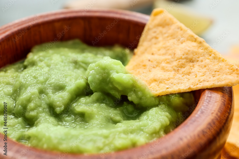 Bowl with tasty guacamole and nacho, closeup Bowl with tasty guacamole and nacho, closeup