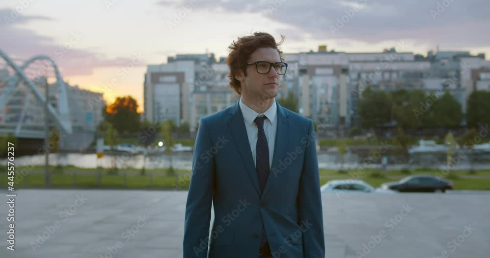 Medium shot of caucasian businessman in stylish formal wear walking outdoors Medium shot of caucasian businessman in stylish formal wear walking outdoors