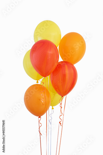 bouquet of yellow and orange balloons on a white background