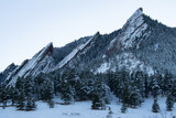 peaks of the boulder flatirons with snow during winter in colorado